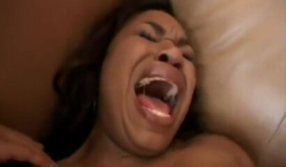 A black woman screams with pleasure during a threesome
